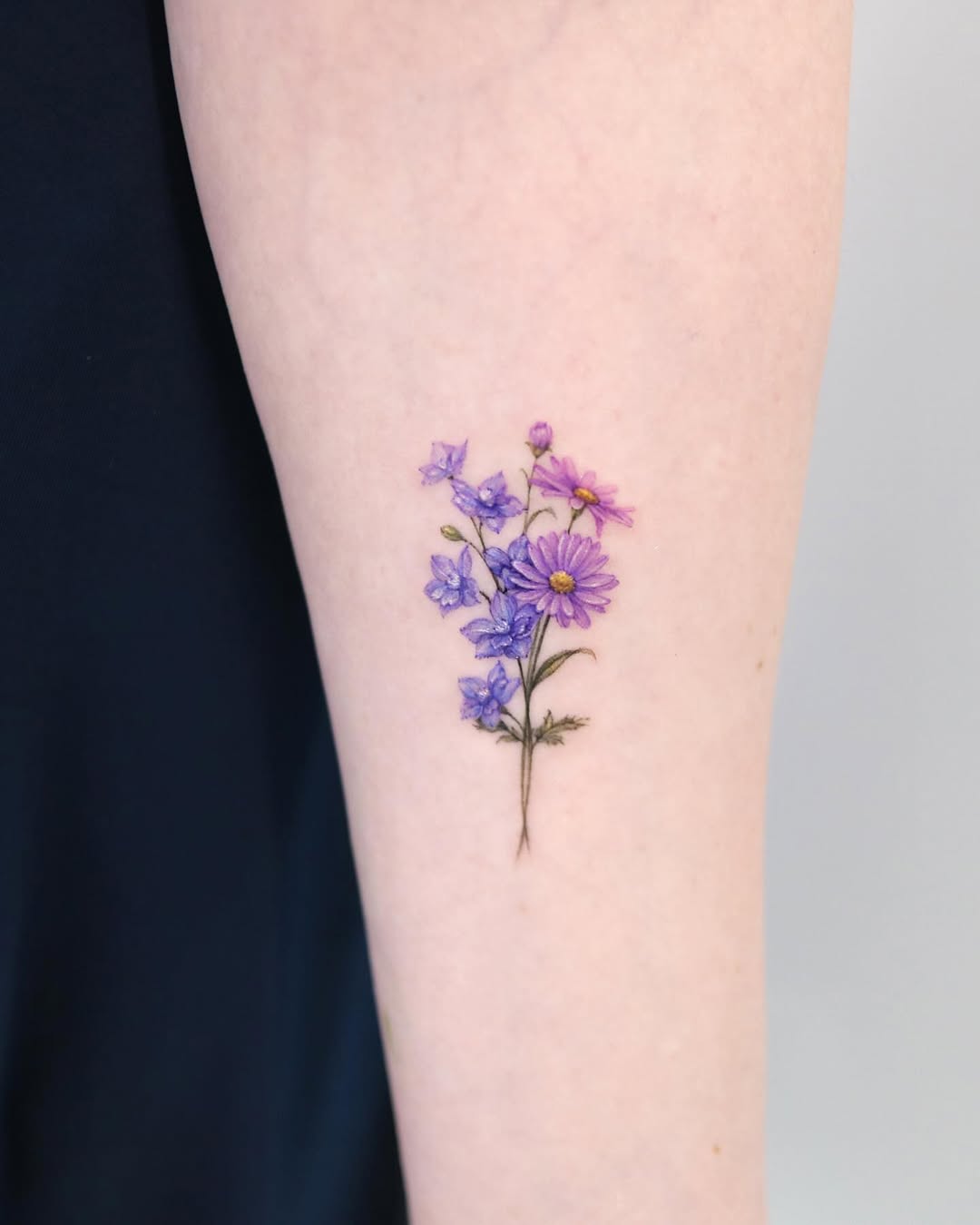 28 Larkspur Tattoo Ideas: Delicate July Blooms with Big Meaning