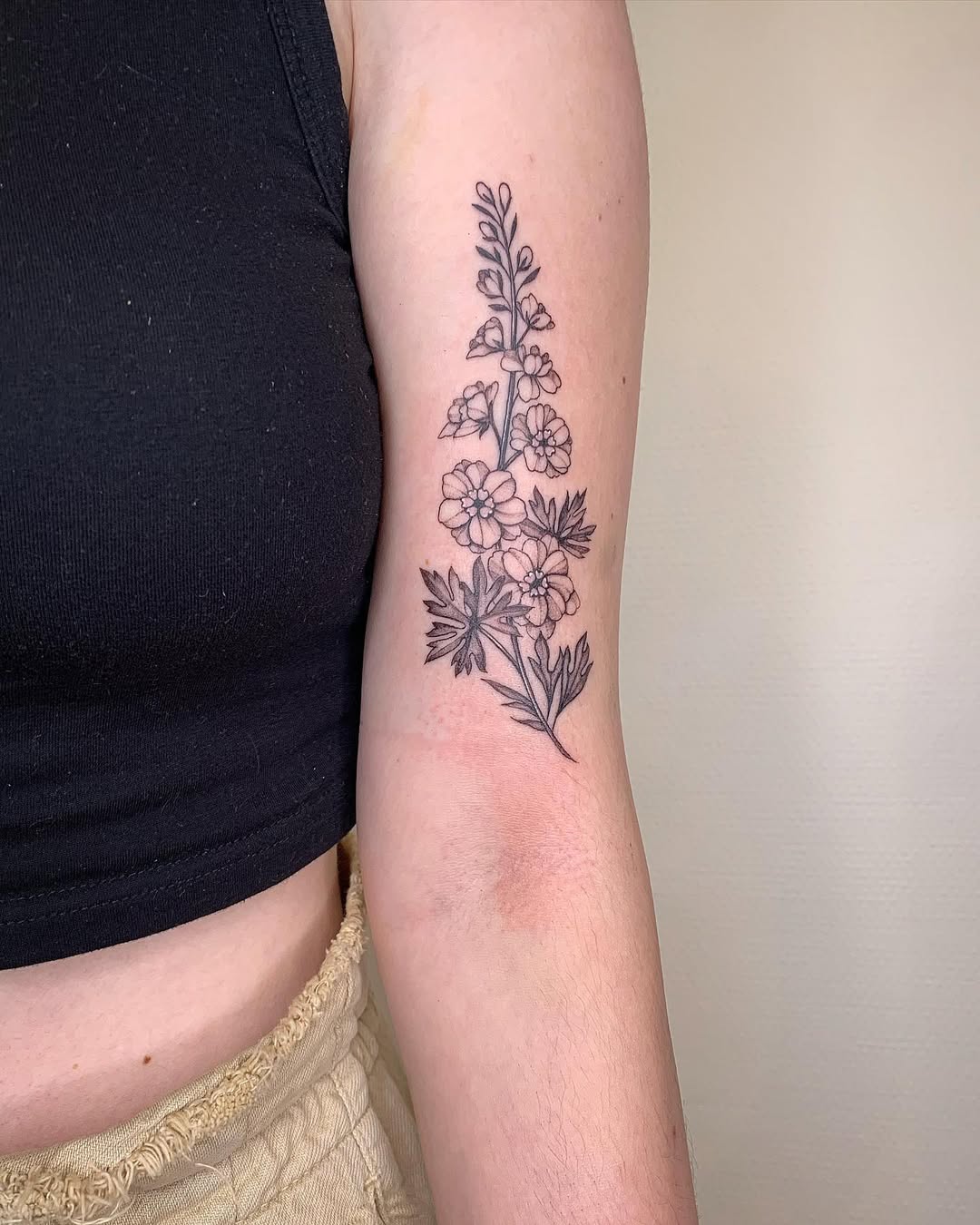 28 Larkspur Tattoo Ideas: Delicate July Blooms with Big Meaning