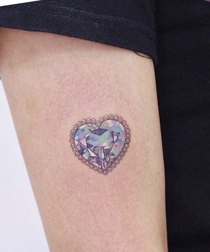 25 Crystal Tattoo Ideas: From Delicate Gemstones to Colorful Botanical Designs